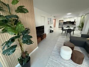 a living room with a couch and a table with a piano at Ocean Reserve Condo by FlatsAway in Miami Beach