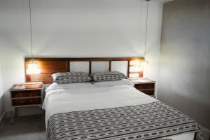 a bedroom with a large bed with two night stands at Marchena de los Olivos in Peñolite +81 photos