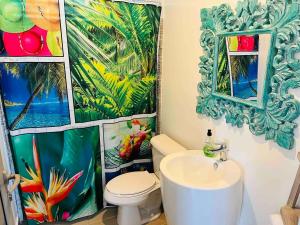 a bathroom with a white toilet and a sink at Green hill in Paea +25 photos