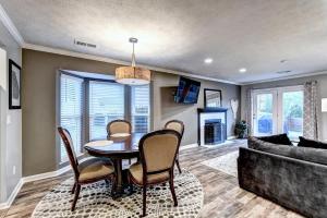 a dining room with a table and chairs and a couch at Alpharetta Dreaming in Alpharetta