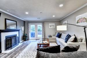 a living room with a couch and a fireplace at Alpharetta Dreaming in Alpharetta