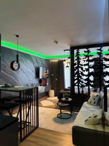 a living room with a couch and a table at Black Elegant & Spa Kop in Kopaonik +52 photos