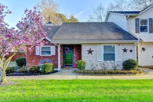 a house with a flowering tree in front of it at Alpharetta Dreaming in Alpharetta