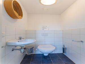 a bathroom with a sink and a toilet at Coastal Family Escape with Enclosed Garden in Renesse +35 photos