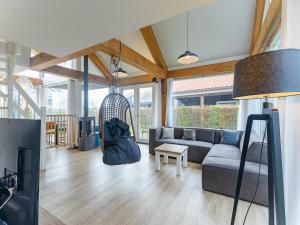 a living room with a couch and a swing at Coastal Family Escape with Enclosed Garden in Renesse
