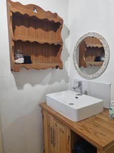 a bathroom with a white sink and a mirror at Pondok in Paternoster +72 photos