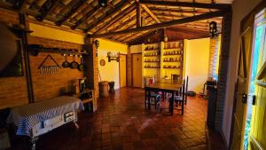 a room with a table and chairs in a kitchen at Pousada Ora Pro Nobis in Catas Altas