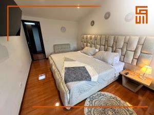 a bedroom with a large bed and a table at Hotel Santa Ana Luxury Rentals - 111 in Bogotá