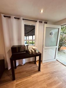 a room with a table with a microwave and a door at La Escondida Cabañas in Mineral del Monte +21 photos