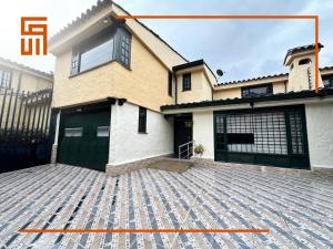 a house with a large driveway in front of it at Hotel Santa Ana Luxury Rentals - 111 in Bogotá