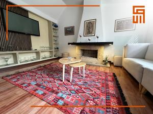 a living room with a table and a fireplace at Hotel Santa Ana Luxury Rentals - 111 in Bogotá