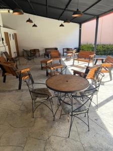 a group of tables and chairs in a patio at La Escondida Cabañas in Mineral del Monte