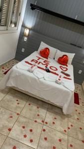 a bedroom with a bed with red hearts on it at Suite Canto da Montanha in Monte Verde +24 photos