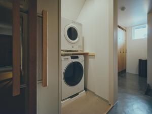 a room with a washing machine and a washer at mont - Nozawa Onsen Ski Resort in Nozawa Onsen