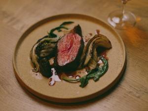 a plate of food with meat and vegetables on a table at mont - Nozawa Onsen Ski Resort in Nozawa Onsen