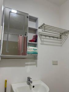 a bathroom with a sink and a mirror at RD Bliss Staycation - SMDC Condo Tower B in Kaybagal +7 photos