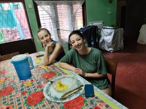 two girls sitting at a table with a plate of food at Villa iSoNet in Weligama