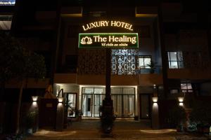 a sign for the healing hotel at night at The Healing Luxury Hotel in Buon Ma Thuot