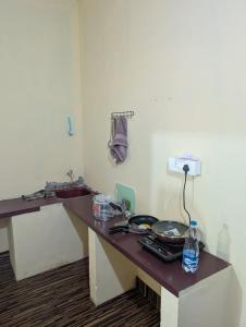 a room with a counter with a table with food at Sri Krishna 4BHK AC Villa in Udupi