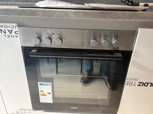 a person is standing inside of an oven at Capital Gate Guest House in Skopje