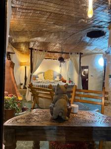 a teddy bear sitting on a table in a bedroom at The Cob House in Chauntrā +10 photos