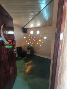a room with a tree with lights on the wall at The Cob House in Chauntrā