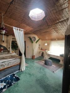 a bedroom with a bed and a potted plant at The Cob House in Chauntrā