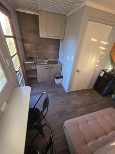 a room with a kitchen with a bed and a sink at Refugio Titi3 in Coronel +12 photos
