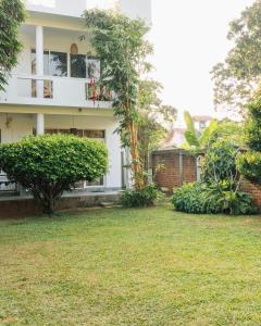 a house with a yard in front of it at Lost Paradise Sri Lanka in Mirissa +61 photos