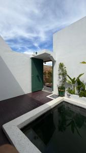 a house with a swimming pool and a green door at Zeman Villa in Padang