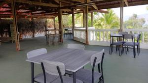 a wooden table and chairs on a patio at Hiva Oa Villa Lodge in Hiva Oa +35 photos