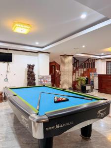 a pool table in a living room at Vang Vieng Sisavang Hotel in Vang Vieng