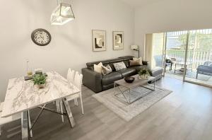 a living room with a couch and a table at Spacious 2BR Lely Resort Condo with Lake View steps to Pool Hot Tub Gym in Naples