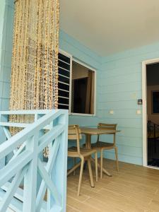 a dining room with a table and a window at Blue Sky Cozy in Paea