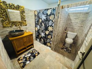 a bathroom with a shower with a sink and a mirror at Blue Sky Cozy in Paea +32 photos
