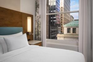 a bedroom with a white bed and a large window at EVEN Hotel Pittsburgh Downtown by IHG in Pittsburgh +59 photos