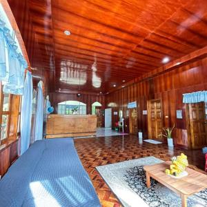 a large room with a wooden ceiling and a table at Alaba Vacation House w Pool and Beach Access in Mambajao