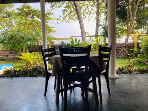 a table and chairs sitting on a patio at Sri Villa in Dickwella