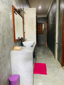 a bathroom with a white sink and a red rug at Sri Villa in Dickwella +21 photos