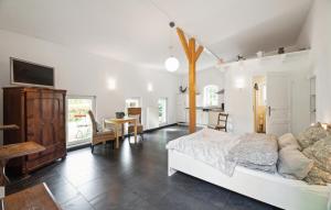 a bedroom with a bed and a table and a kitchen at Beautiful Apartment In Wingst in Wingst