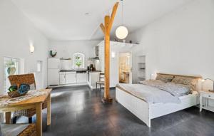 a bedroom with a bed and a table and a kitchen at Beautiful Apartment In Wingst in Wingst