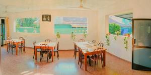 a dining room with tables and chairs in it at Sunny Lanka Guest House in Matara