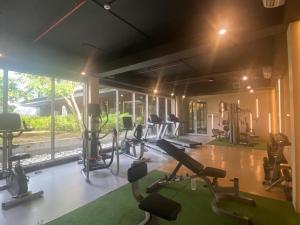 a gym with several treadmills and elliptical machines at DeAr Caspian Grand Sunkono Lagoon Apartment in Surabaya