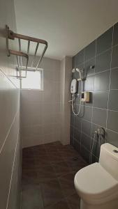 a bathroom with a toilet and a shower at C&CDreamland hotel in Ipoh