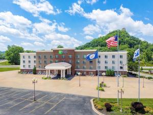 a hotel with two flags in a parking lot at Holiday Inn Express Winona by IHG in Winona