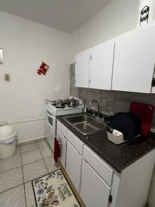 a kitchen with a sink and a stove at Grandma House in Carolina +86 photos