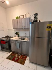 a kitchen with a stainless steel refrigerator and a sink at Grandma House in Carolina