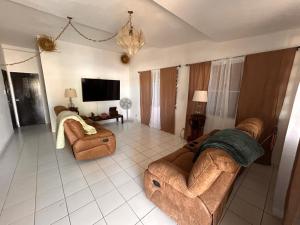 a living room with two couches and a tv at Grandma House in Carolina