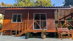 a wooden house with a large deck at Slow Home in Ban Yang Mae Luang