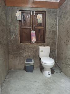 a bathroom with a toilet and a trash can at Slow Home in Ban Yang Mae Luang +25 photos